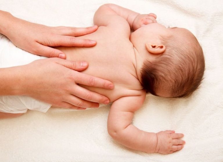 un ostéopathe en train de soigner un bébé