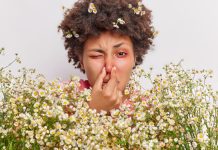 Une femme se bouche le nez pour éviter les allergies