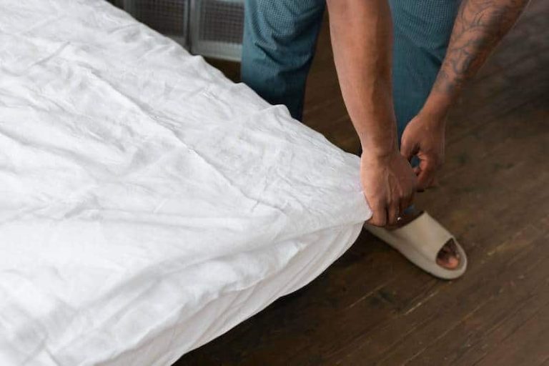 Homme vérifiant que son lit n'est pas infesté de punaises de lit.