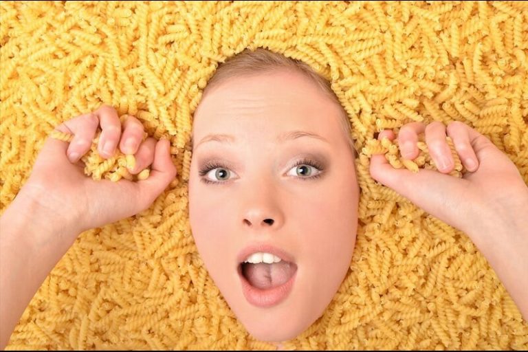 Une femme entourée de pâtes (féculents) car c'est les principaux aliments du régime sans résidus.