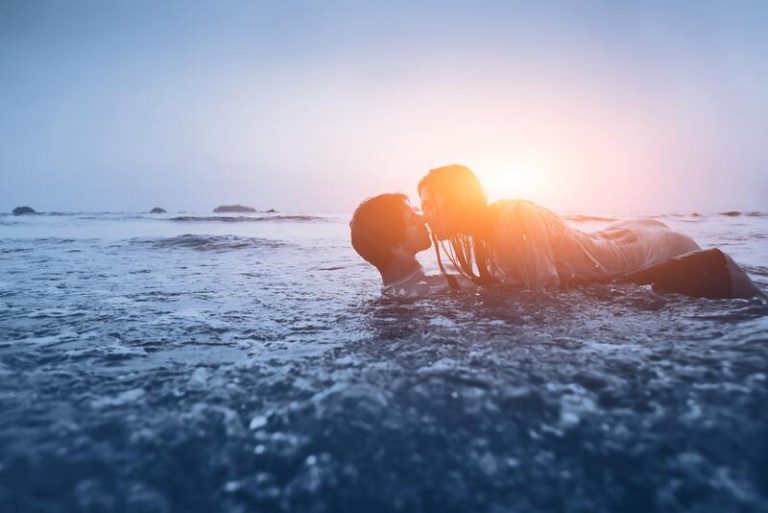 Un couple qui s'embrasse sur la plage.