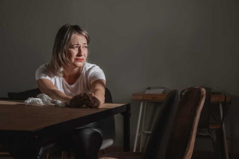 Une femme en dépression liée aux fluctuations hormonales de la ménopause.