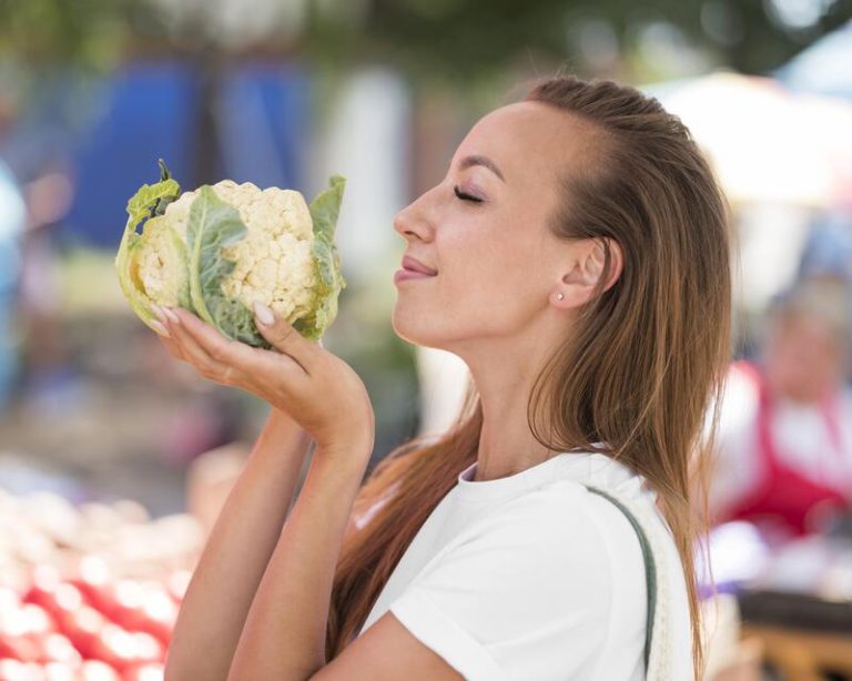 Une femme végétarienne, heureuse de protéger sa santé grâce à son alimentation.