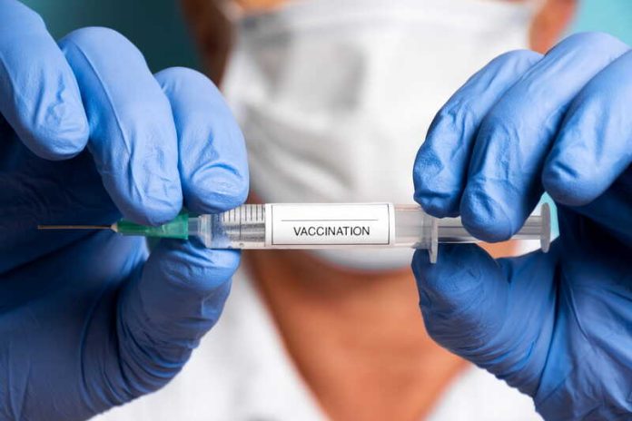 Complots, peur, antivax pourquoi des Français refusent encore les vaccins Ma Santé Un médecin tenant un vaccin dans les mains pour promouvoir la vaccination.