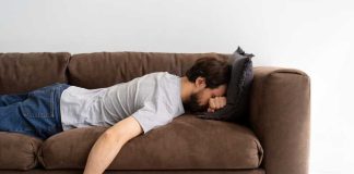 Sommes-nous vraiment paresseux par nature ? Un jeune homme paresseux qui préfère ne rien faire sur son canapé.