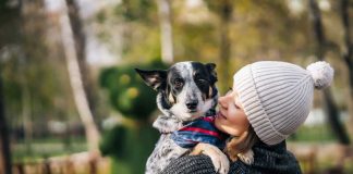 Chiens, chats : leur présence fait vraiment du bien au moral ! Une femme qui porte son chien comme un enfant.