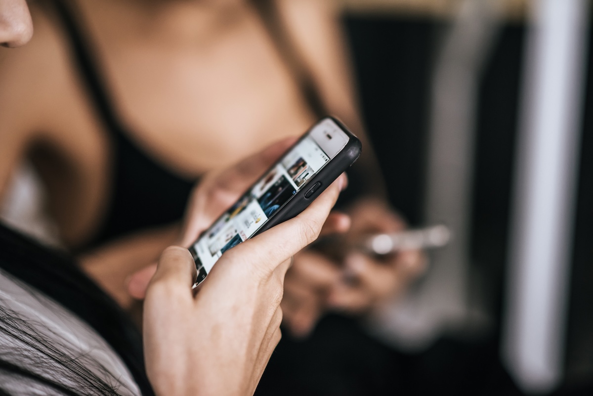 Une jeune fille de moins de 15 ans, scotchée à son téléphone, regarde les réseaux sociaux.