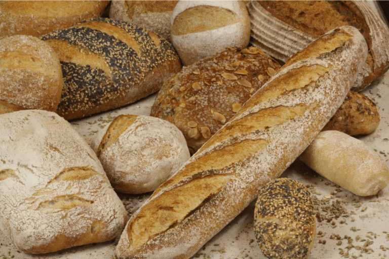 Assortiment de pains (baguette, pain complet et pains aux graines).